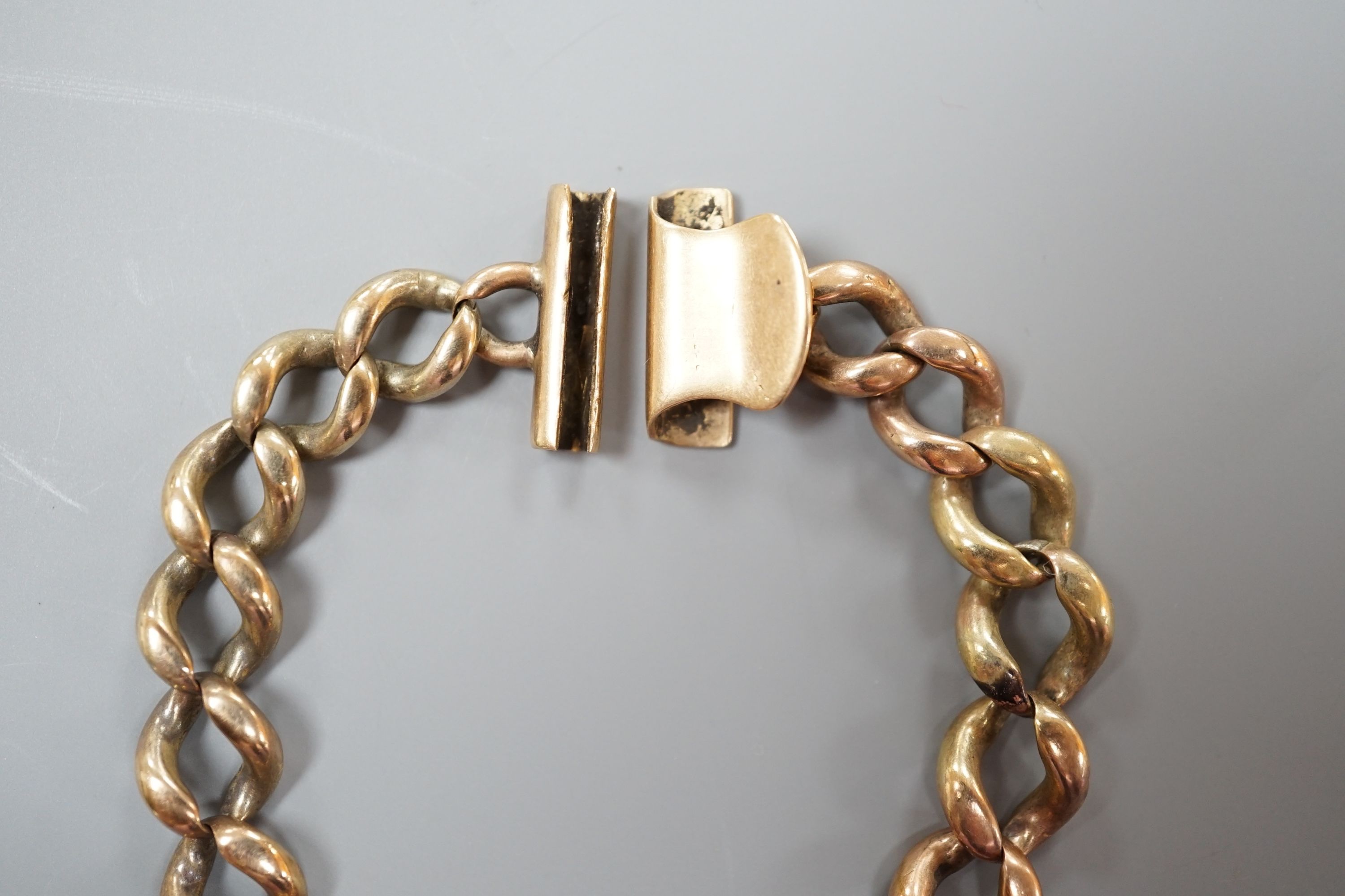 A yellow metal curb link bracelet, 14cm